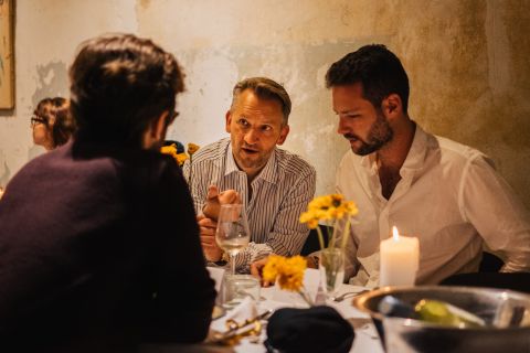 Intimate founder dinner networking conversation between B2B tech executives